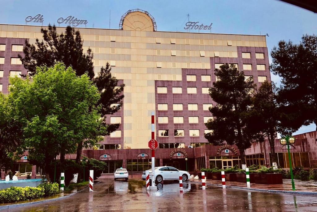 a building with a car parked in front of it at Ak Altyn in Ashgabat