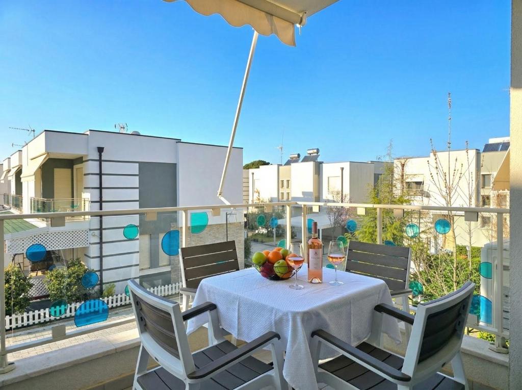 a table with a bowl of fruit on a balcony at Sunny Beach Apartments - 146 in Mullini i Danit