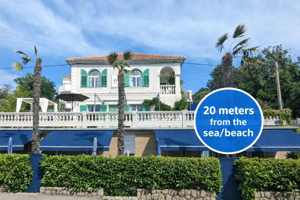 a house with a sign that reads meters from the sea beach at Pavi apartments Vila Amalia in Šilo