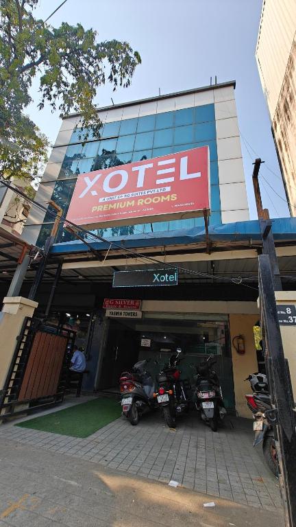 two motorcycles parked in a garage in front of a building at Open Hotel by Olive - Ashok Nagar in Chennai