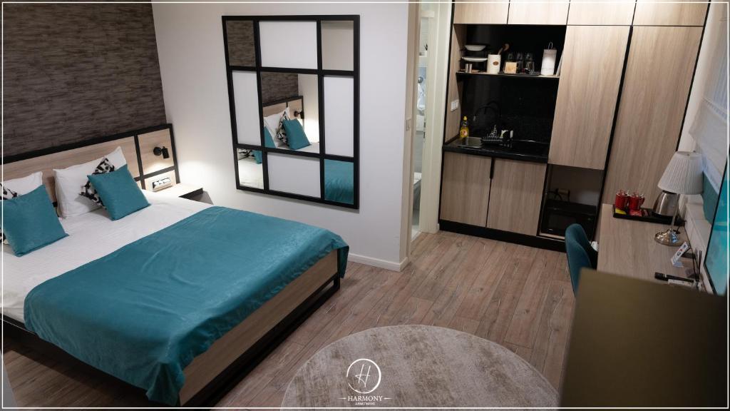 Harmony apartment bedroom with large bed and blue cover — Harmony - Apartmani Tuzla
