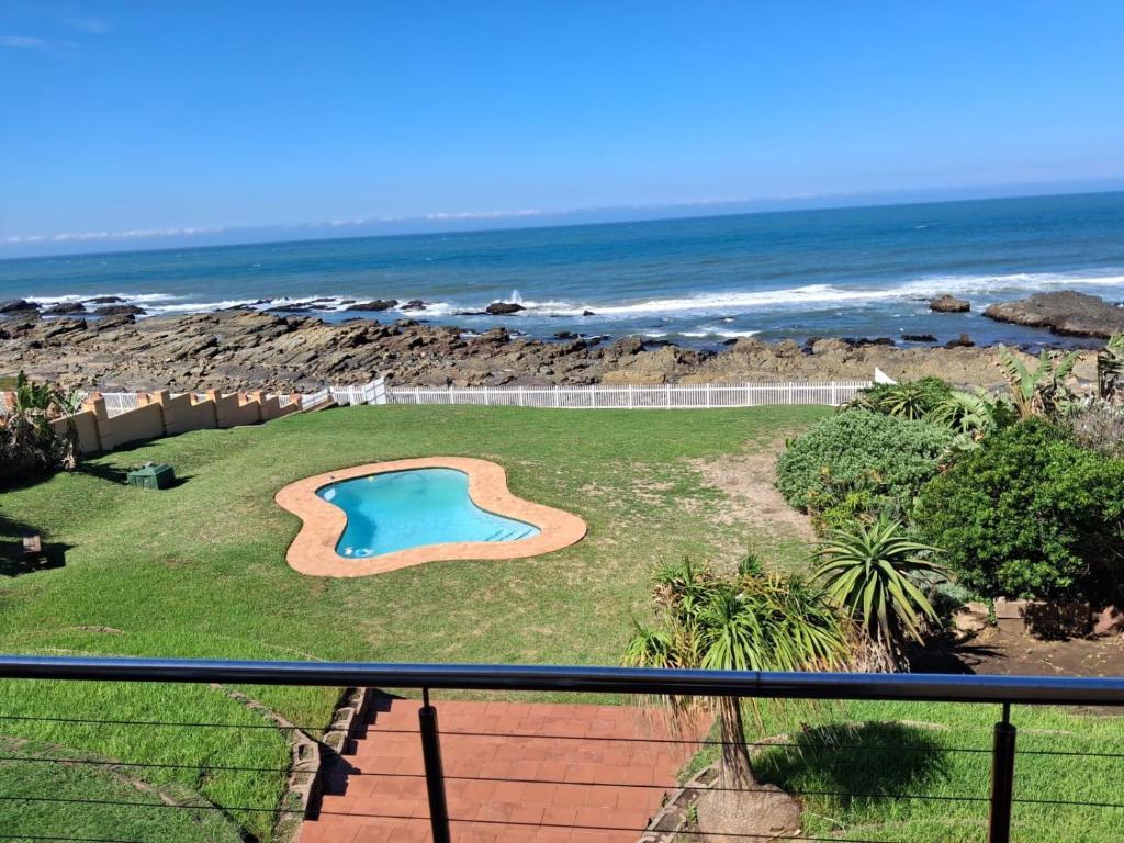 a view from a balcony of a swimming pool and the ocean at Seaside on Southend in East London