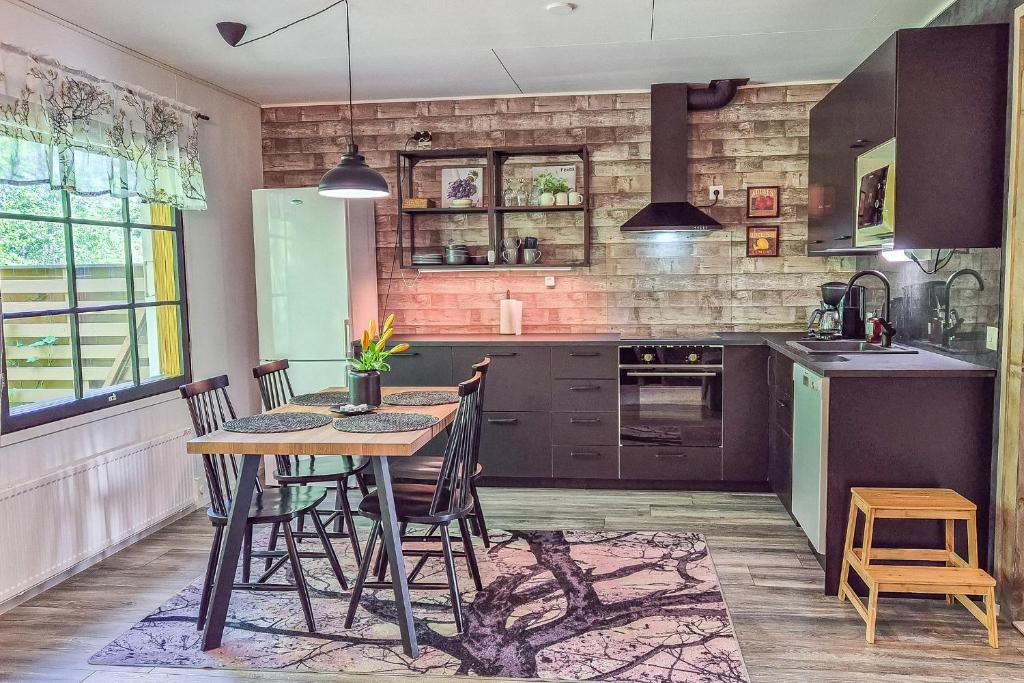 a kitchen with a table and chairs in a room at Kotokatti in Vuokatti