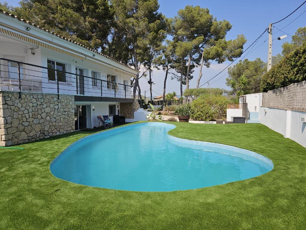 a swimming pool in the yard of a house at La Casa Delviga in Olivella