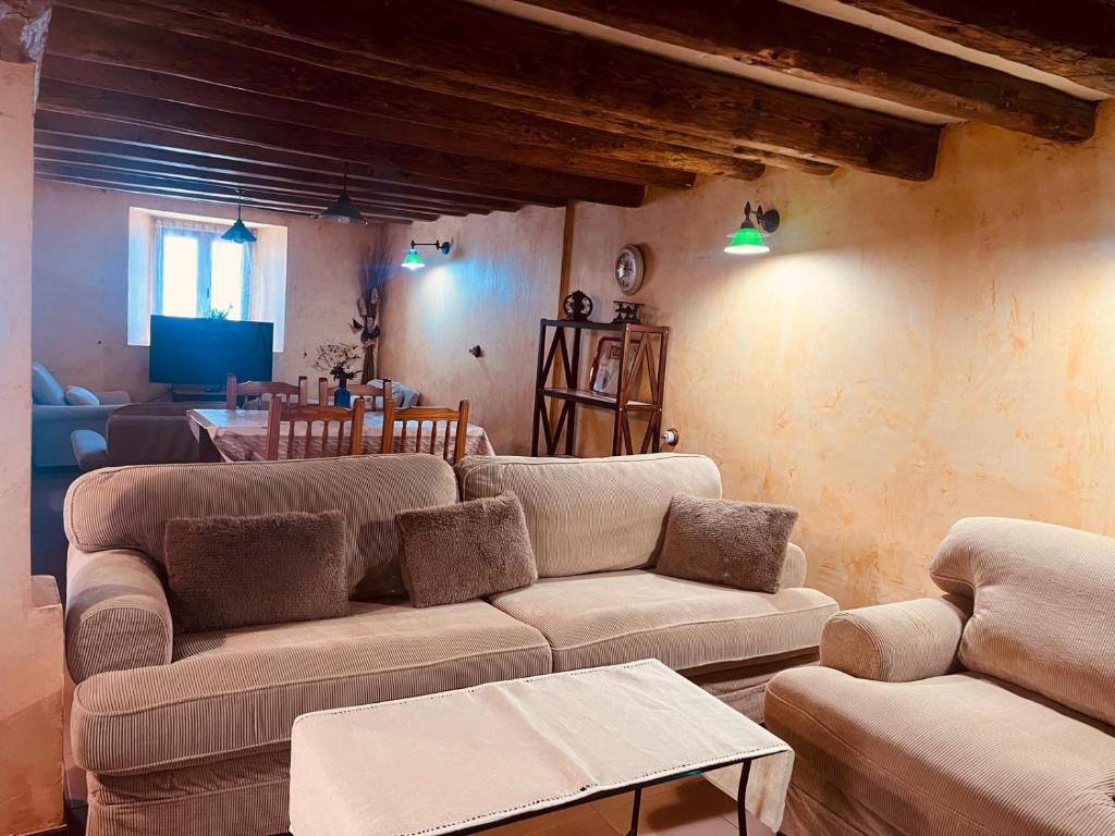 a living room with a couch and a table at Navas de Lema in Las Navas de Buitrago