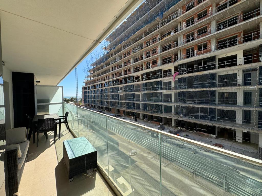 a balcony with a view of a large building at Brisa Azul in Cabanes