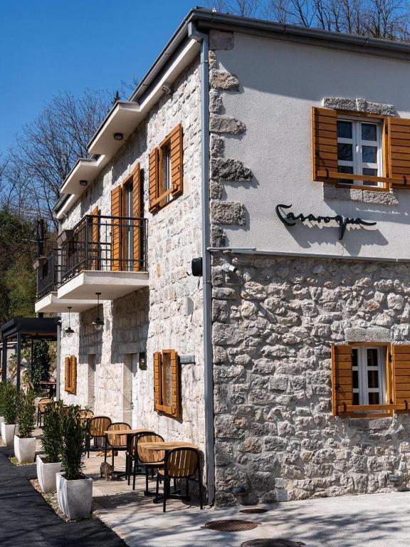 a building with tables and chairs in front of it at Casarogna Luxury Rooms in Cetinje