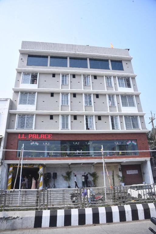 a tall building with a store in front of it at LL Palace in Hinganghāt