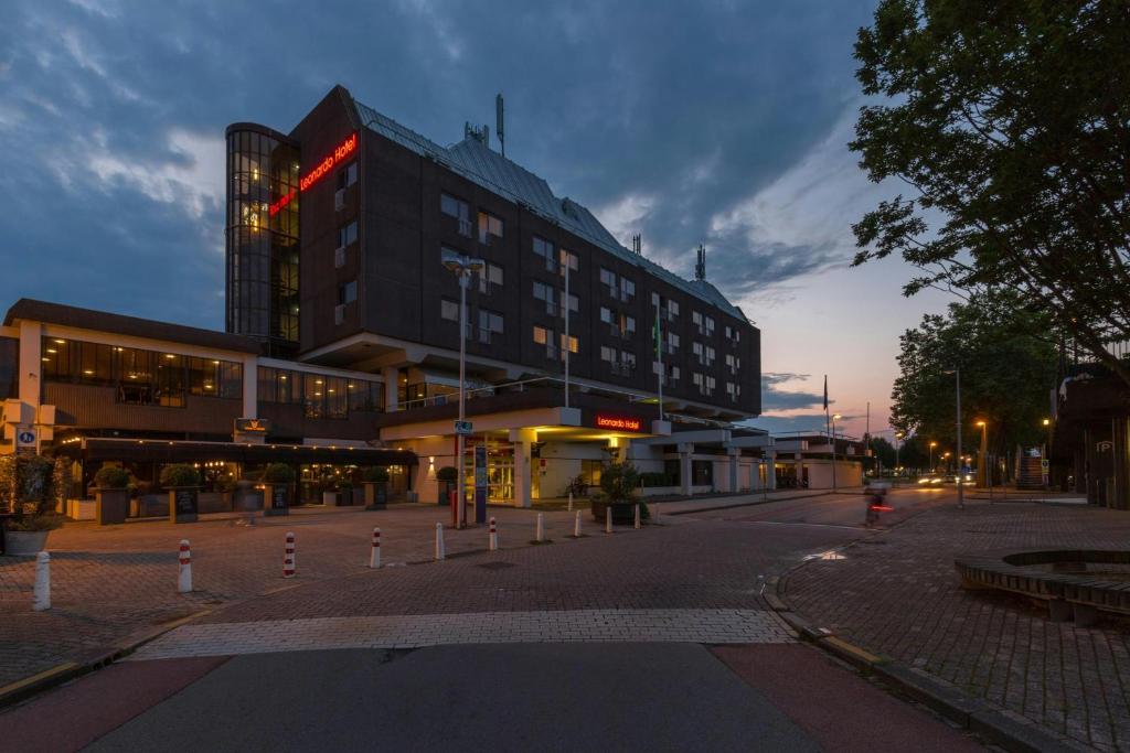 a building on a city street with a building at Leonardo Hotel Lelystad City Center in Lelystad