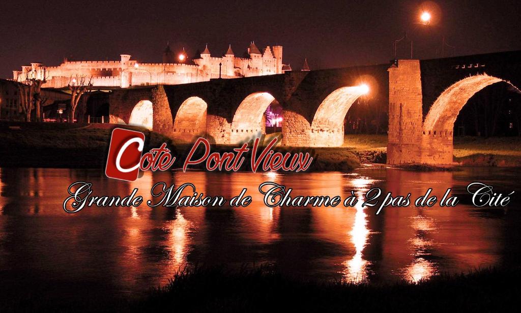 a picture of a bridge with a castle at night at Appartements Cote pont Vieux-Self Check-In in Carcassonne