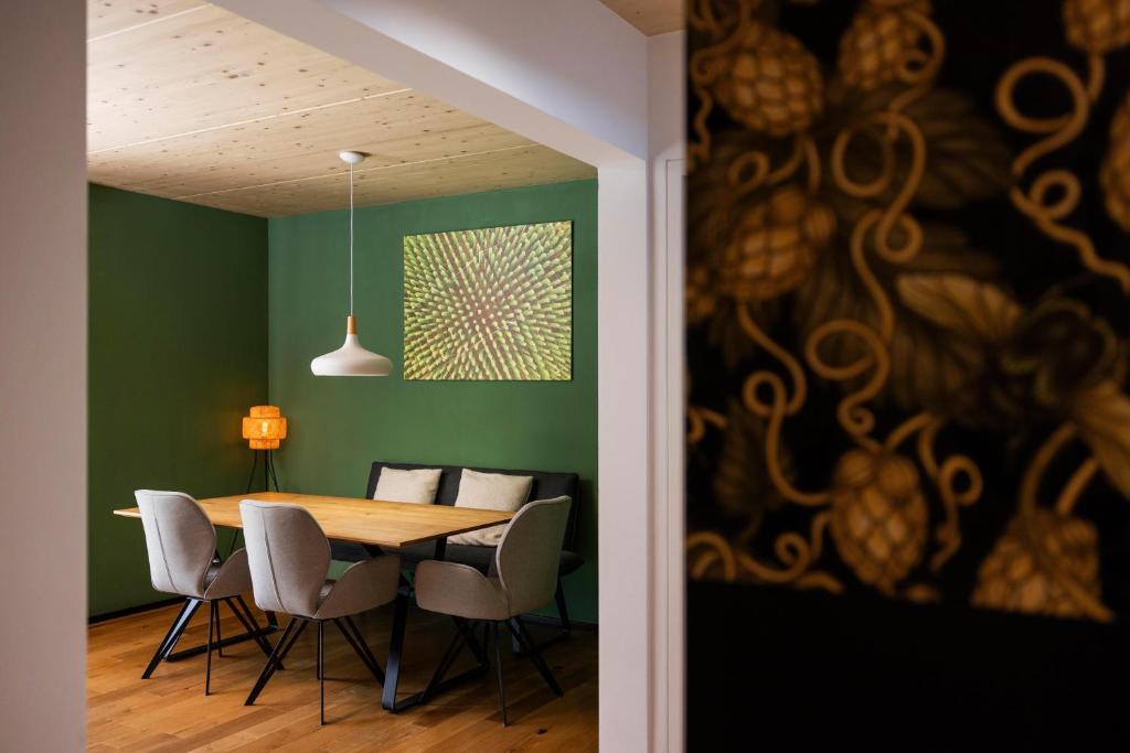 a dining room with a wooden table and chairs at Hinterland&See in Tettnang
