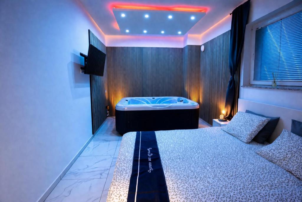 a bedroom with a tub in the middle of a room at Luxury Apartment Brendi in Log pri Brezovici