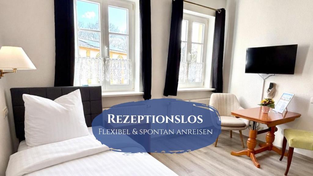 a bedroom with a bed and a desk and window at Schlösschen am Rhinufer in Alt Ruppin