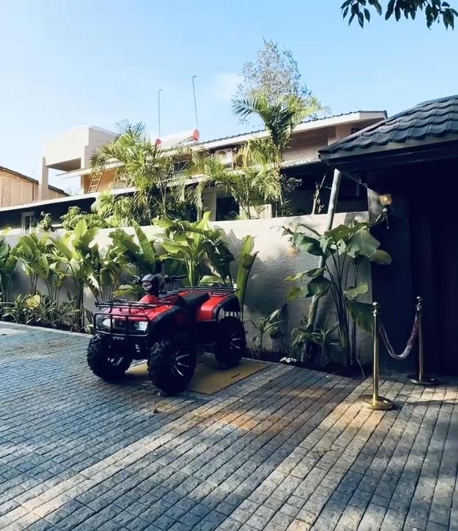 a red atv parked in front of a building at The S - Luxurious Stays in Mahabaleshwar