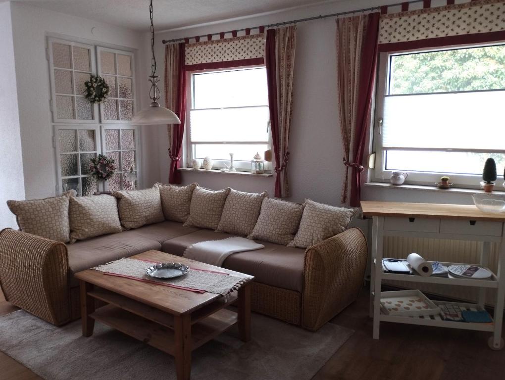 ein Wohnzimmer mit einer Couch und zwei Fenstern in der Unterkunft Thüringer Pforte in Gorsleben