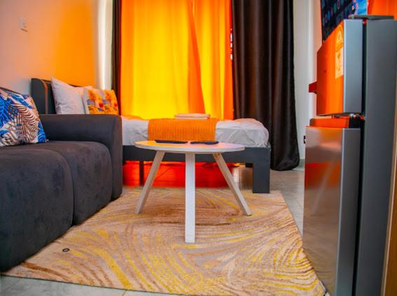 a living room with a couch and a table at Kanotis place in Ongata Rongai 