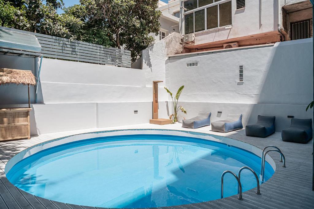 a swimming pool with blue water in a backyard at Grand Residences in Chania