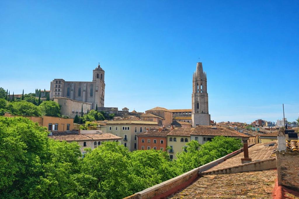 a view of a city with a clock tower at Hostal Milana Girona in Girona
