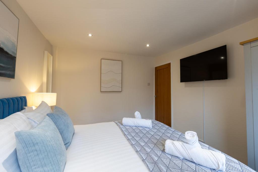 a bedroom with a bed with a television on the wall at Newhaven in Telford