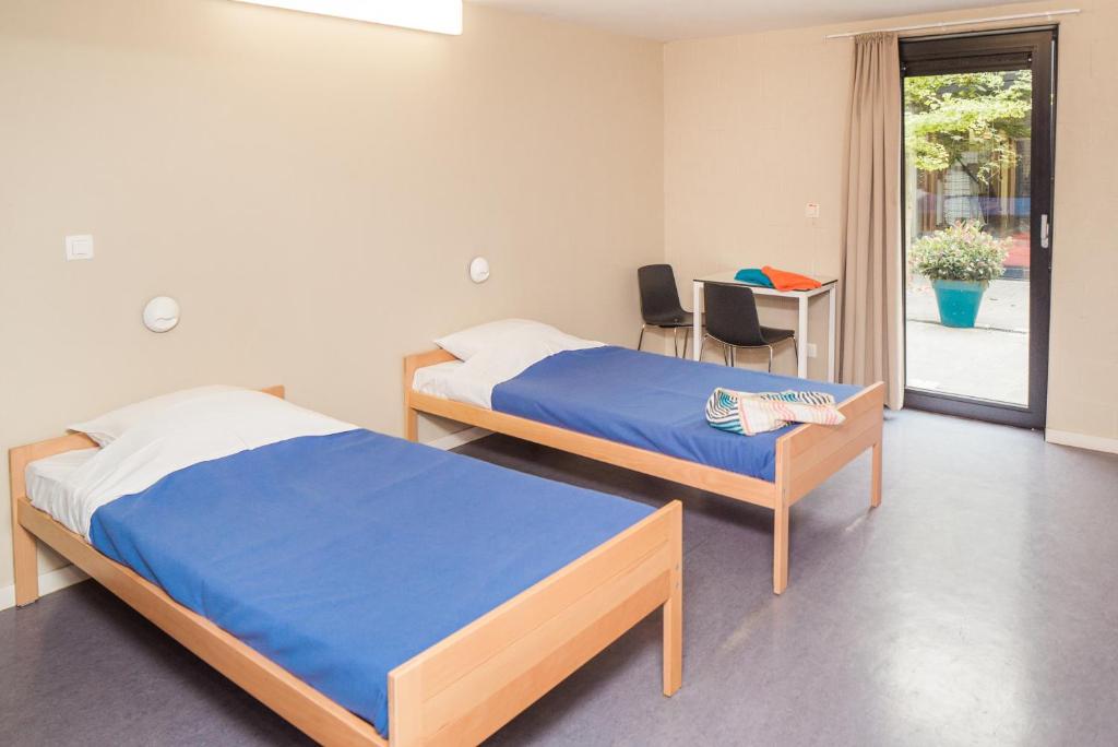 Postel nebo postele na pokoji v ubytování Hostel De Veurs