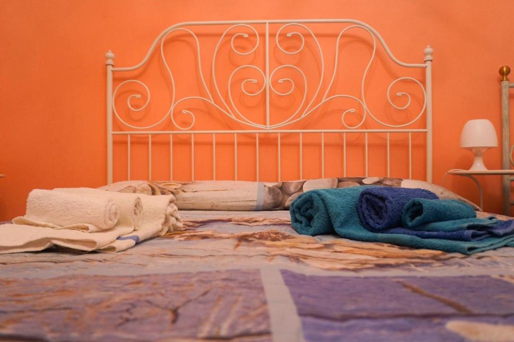 a bed with blankets and towels on top of it at Stella Marina in Giardini Naxos