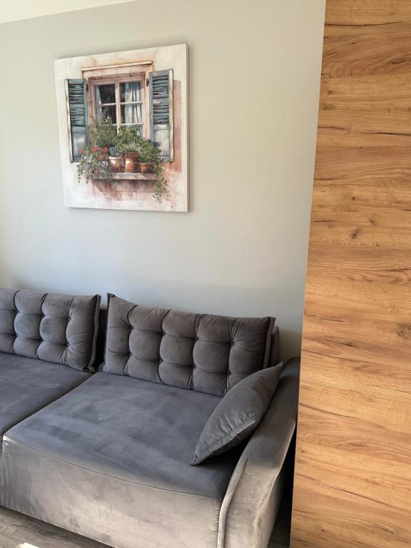 a living room with a couch and a window at Studio between two stations in Šiauliai