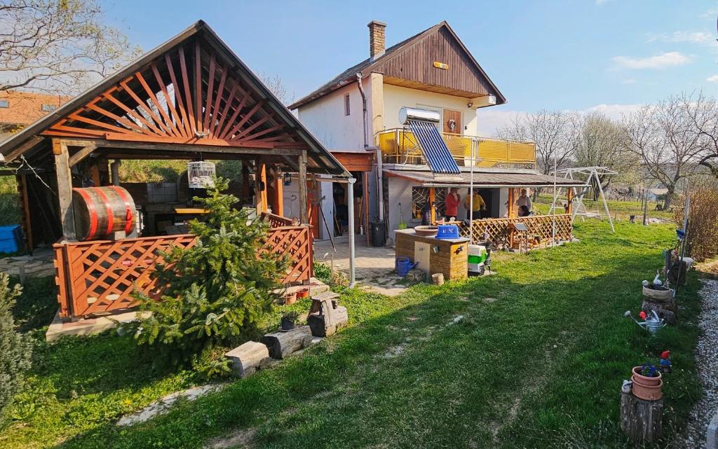 a house with a fence and a yard with a house at Oscar Apartman Rezi in Rezi