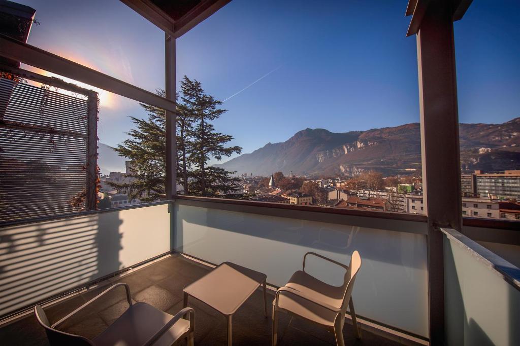 a dining room with a view of the ocean and mountains at La Villa - Luxury Guest House in Trento