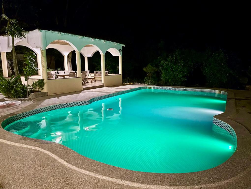 a swimming pool at night with a gazebo at Le Jardin du Saloum in Toubakouta