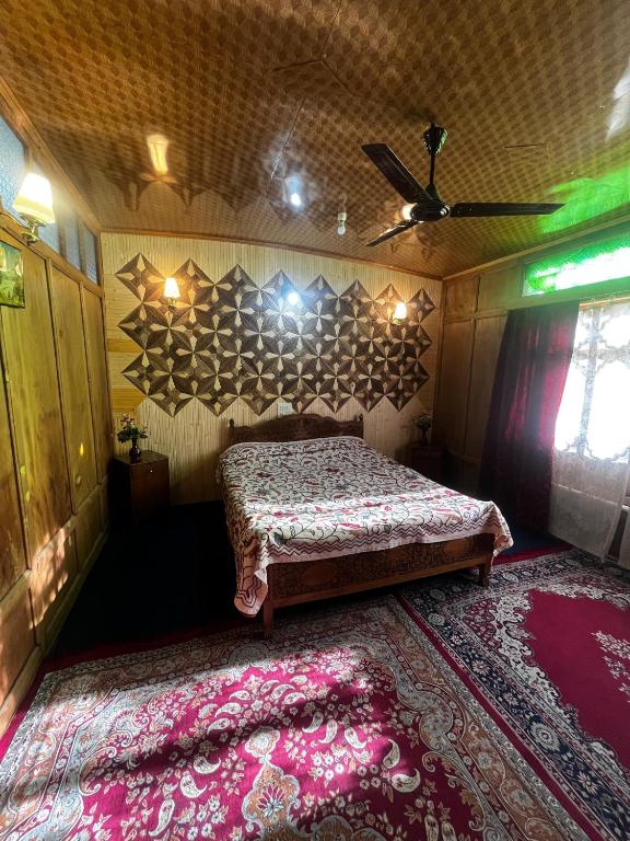 a bedroom with a bed in a room with a rug at Houseboat Nightingale in Srinagar