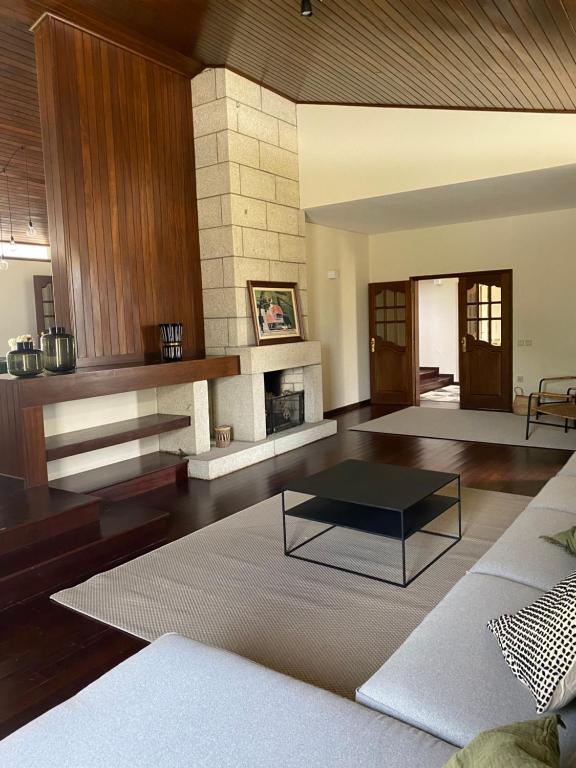 a living room with a coffee table and a fireplace at Barcelos Residence Living in Barcelos