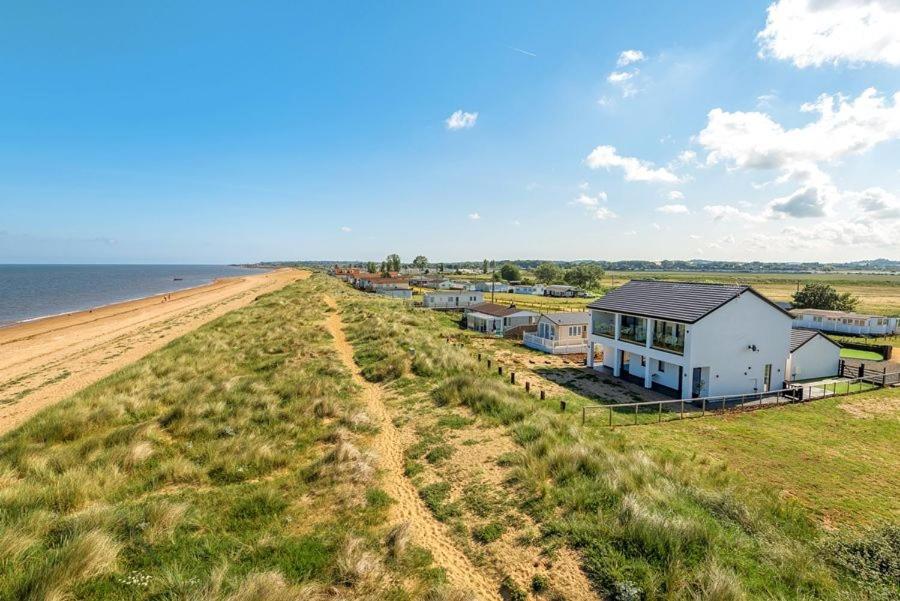 an aerial view of a house on the beach at Washington Beach House with Lodge in Heacham
