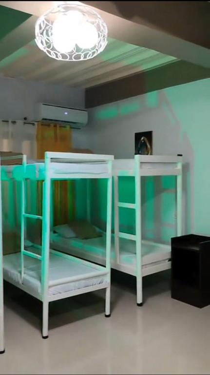 two bunk beds in a room with a ceiling at Pacifico's Hostel in Barili