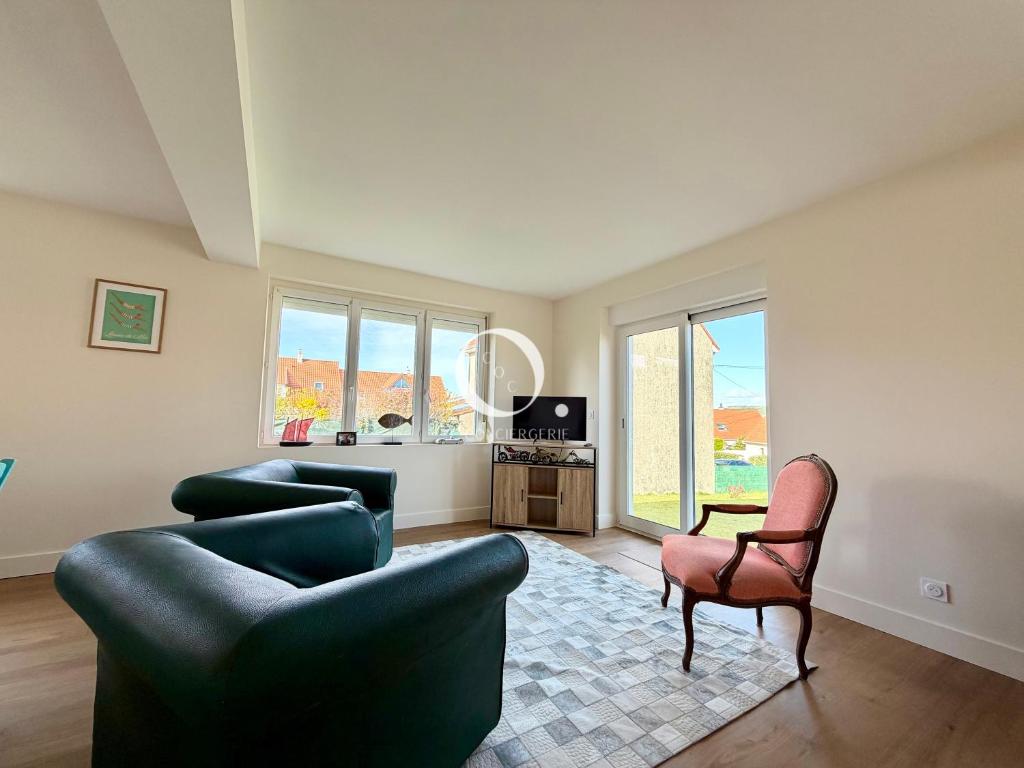 a living room with two couches and a chair at GC - La Voile Bleue in Wissant