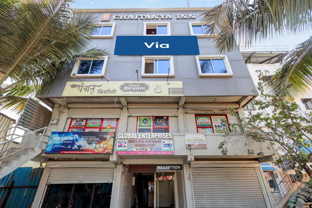 a building with a sign on the front of it at Via Chaitanya Inn in Pune
