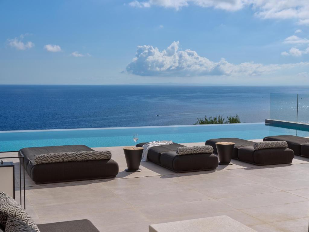 a patio with a view of the ocean at On The Rocks 7 Bedroom Villa in Koríthion