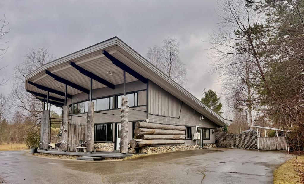 a large house with a gambrel roof at Villa Cuisine in Joensuu