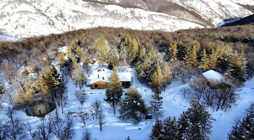 an aerial view of a house in the snow at Anima Resort Aghveran - Forest Retreat in Aghveran