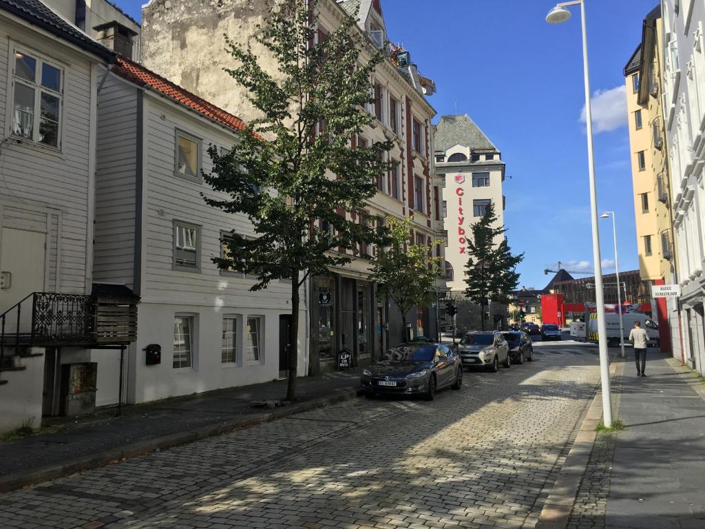 a street with cars parked on the side of a road at Bergen City Apartment Nygårdsgaten in Bergen