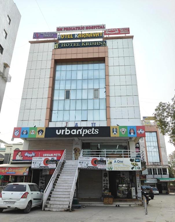 a building with an entrance to a store at Hotel Karnavati Motera Ahmedabad in Ahmedabad