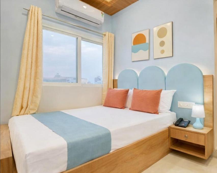 a bedroom with a large bed with a window at Anushka Stays Varanasi in Varanasi
