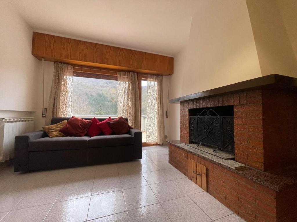 a living room with a couch and a fireplace at LHE Terrazza Alba in Bagno di Romagna