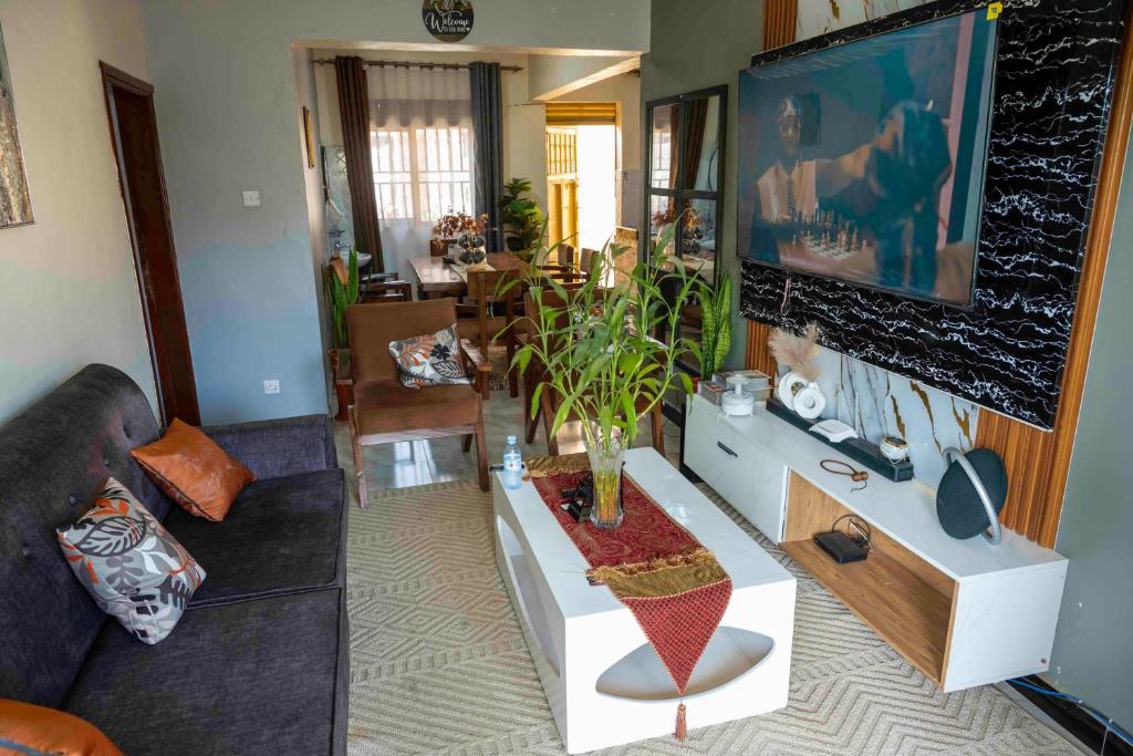 a living room with a plant on a table at Urban Escape Apartment in Mbarara