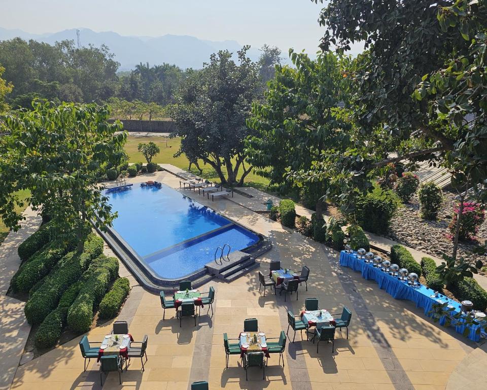 an overhead view of a pool with tables and chairs at Mana Ranakpur in Ranakpur