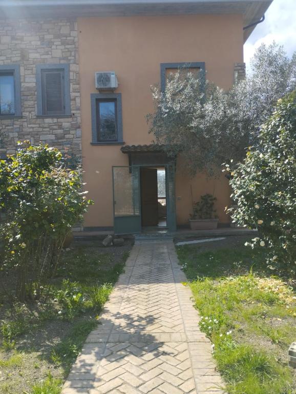 a house with a walkway in front of it at Villa Roverella Sutri Home Sweet Home Viterbo in Sutri