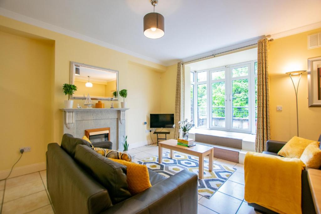 a living room with two couches and a fireplace at Spacious 4-Bed Central Limerick Group Retreat in Limerick