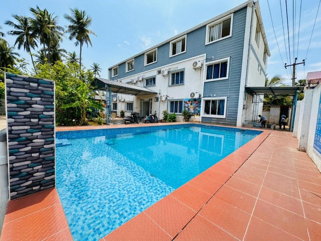 a swimming pool in front of a building at SS Grand with swimming pool in Pondicherry