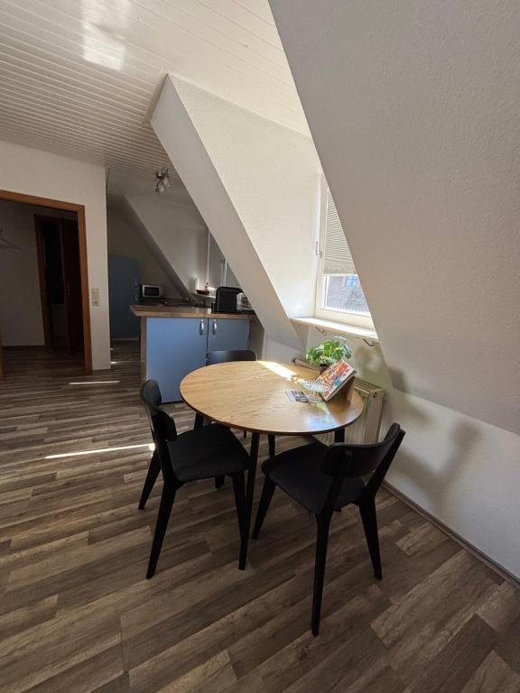 a dining room with a table and chairs in an attic at See You 2 in Germersheim