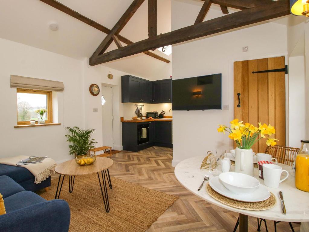 a living room with a blue couch and a table at The Blacksmiths Shop in Bromyard