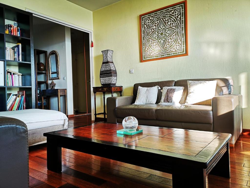 a living room with a couch and a coffee table at Charming 96m2 fantastic view in Tourcoing